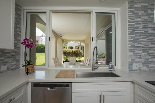 a kitchen with a sink and a mirror at Wailea Hidden Gem in Wailea