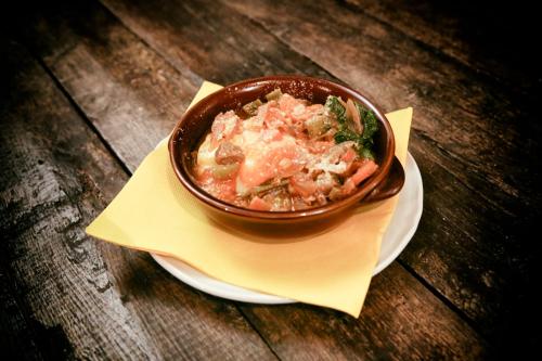 a bowl of food on a plate on a table at Agriturismo Ristorante Monte Argentario in Monte Argentario