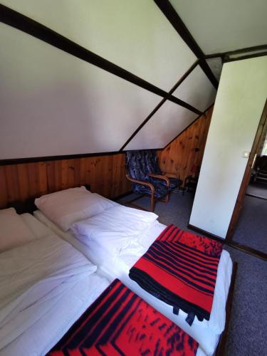 a bedroom with a bed and a rug in a tent at Ośrodek Wypoczynkowy "U Kulasa" in Warchały