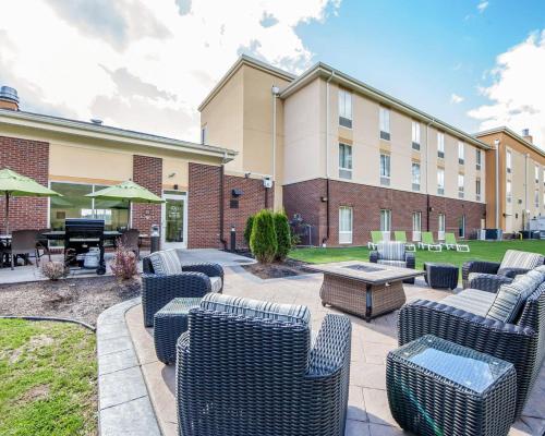 a patio with chairs and a table in front of a building at Comfort Suites Marietta-Parkersburg in Marietta