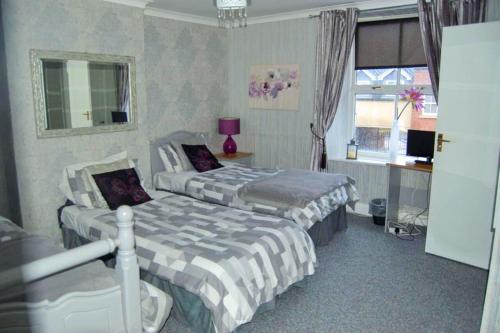 a hotel room with two beds and a window at OYO La Spada Boutique Hotel in Durham