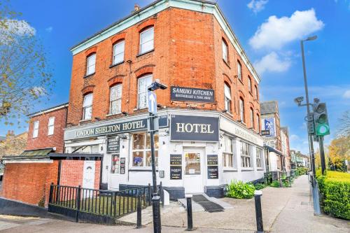 a brick building with a hotel on a street at London Shelton Hotel, Finsbury Park in London