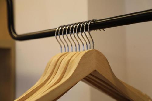 a bunch of wooden chopsticks hanging on a rack at Vila Murati in Ksamil