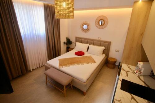 a bedroom with a bed with a red flower on it at Vila Murati in Ksamil