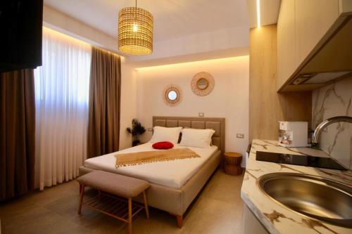 a bedroom with a bed and a sink in it at Vila Murati in Ksamil