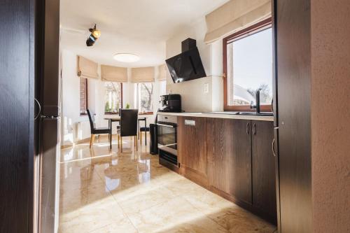 a kitchen with a table and a dining room at Dom v stráni in Poniky