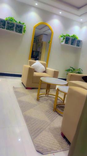 a living room with a couch and a table and a mirror at AHWERA Beautiful Homes in Kampala
