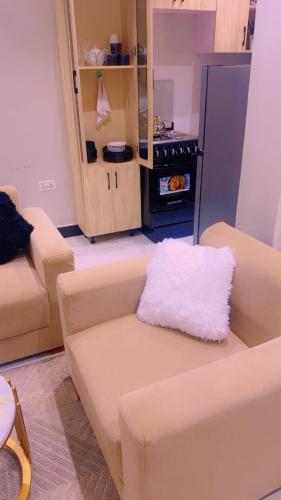 a living room with a couch and a stove at AHWERA Beautiful Homes in Kampala
