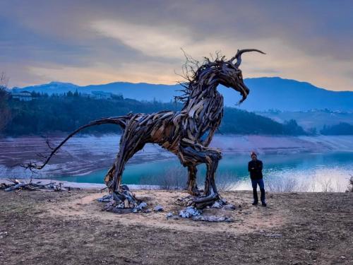 a man standing next to a statue of a horse at Loft 69 - Green Relax in Cles