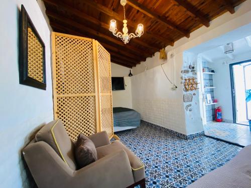 a living room with a couch and a chandelier at Badehan Guest House in Cesme