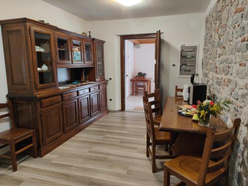 a dining room with a wooden table and chairs at Casa Beuzer in Cividale del Friuli