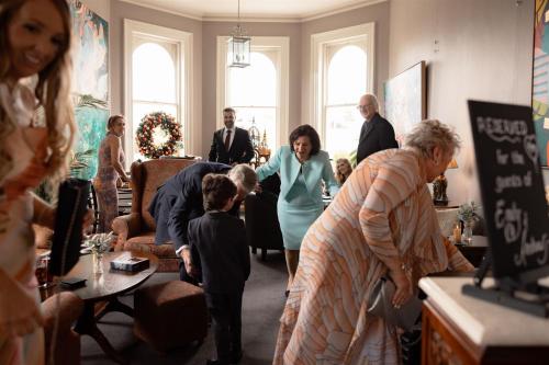 a group of people standing in a living room at The Royal Queenscliff in Queenscliff