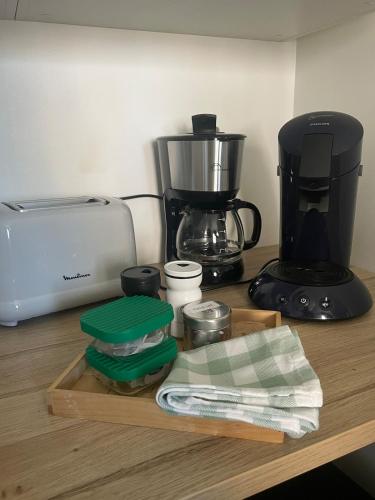 a kitchen counter with a coffee maker and a mixer at Le Chez Moi Hyper Centre Parking 3mn Gare in Montigny-le-Bretonneux