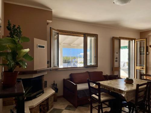 a living room with a couch and a table at The Front Beach Penthouse 20 m by Salento Prime in Marina di Pescoluse