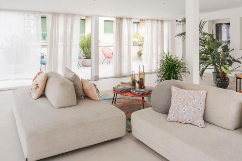 a living room with two couches and a table at Elysium Boutique Apartments - Catania in Catania