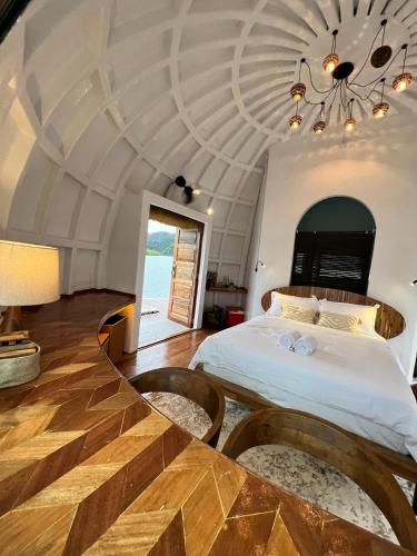 a bedroom with a large bed with a ceiling at Coconest ONE Langkawi in Tanjung Rhu 