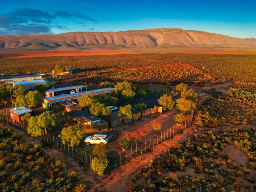 an aerial view of a building in the middle of a desert at Natures Rest Lapa in Oudtshoorn
