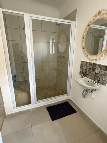 a bathroom with a shower and a sink at Wittus Retreat in White River