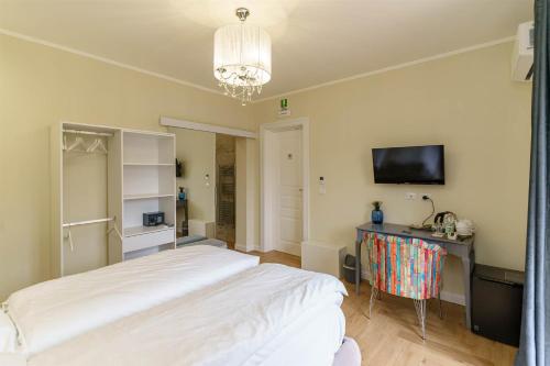a bedroom with a bed and a desk and a television at B&B San Pancrazio hotelHouse in Catania