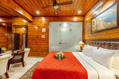 a bedroom with a large bed with a red blanket at Salcete Beach Resort in Colva