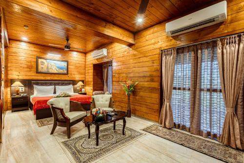 a bedroom with a bed and a table in a room at Salcete Beach Resort in Colva