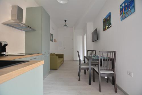 a kitchen and dining room with a table and chairs at 7th Floor - Donoratico in Cagliari