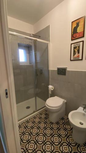 a bathroom with a shower and a toilet and a sink at Casa Margherita in Naples