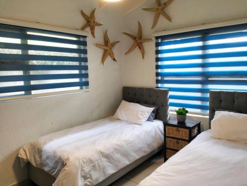 two beds in a room with stars on the wall at Modern Beachfront Unit with Breathtaking Seaview's in Mtwalume