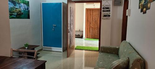 a living room with a couch and a table and a door at CERRY BERRY Homestay in Guwahati