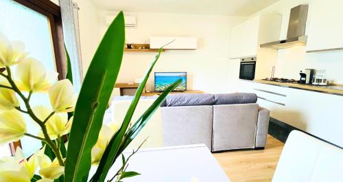 a living room with a couch and a table at Vela House & Garden City Center in Olbia