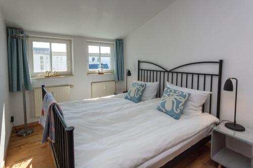 a bedroom with a large bed with blue pillows at Seepark Sellin - Apt. 382 in Ostseebad Sellin
