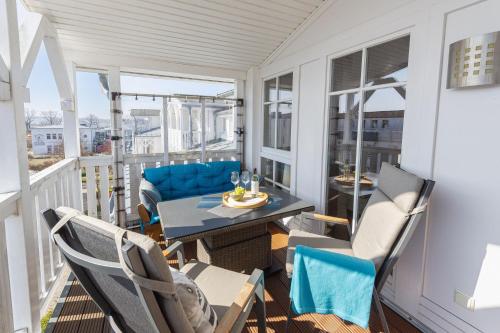a porch with a table and chairs on a balcony at Seepark Sellin - Apt. 382 in Ostseebad Sellin