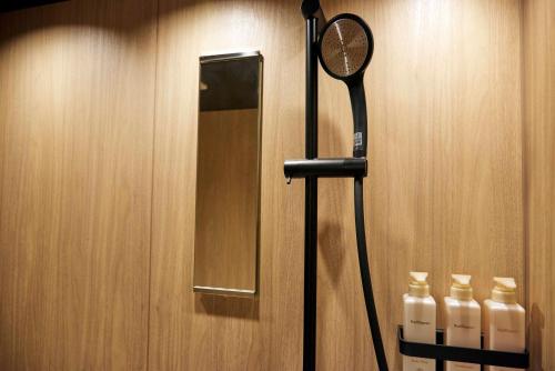 a bathroom with a blow dryer and a mirror at MKG HOTEL Asakusa in Tokyo