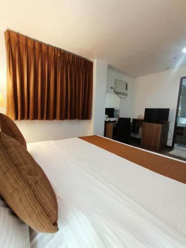 Ένα ή περισσότερα κρεβάτια σε δωμάτιο στο Tyche Boutique Hotel