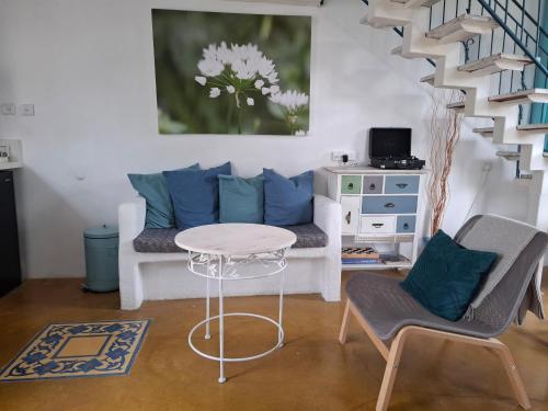 a living room with a couch and a table and chairs at Yamas in Ani'am