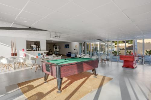 a living room with a pool table in it at Bluewater Hotel in Colonia Sant Jordi