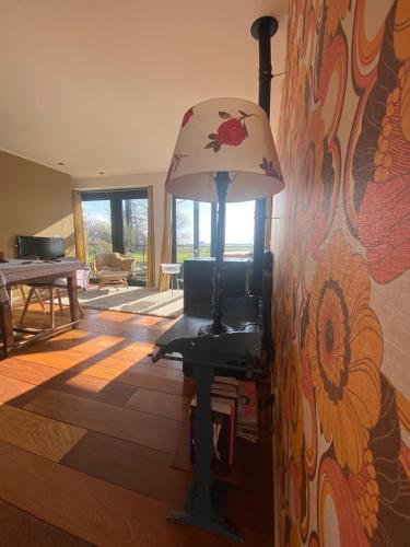 a lamp sitting on a table in a living room at B&B NR6 in Herbaijum