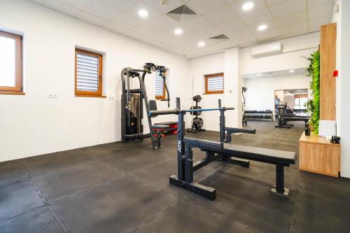 a gym with treadmills and a bench in a room at Tci Social Club in Cluj-Napoca