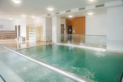 a large pool of green water in a building at Tci Social Club in Cluj-Napoca