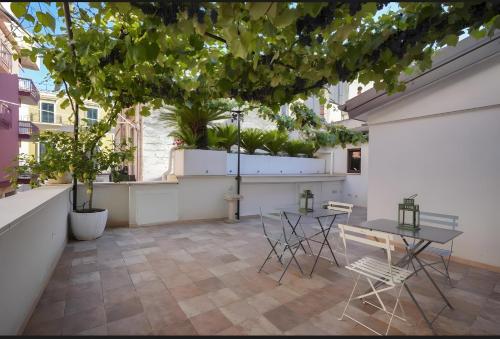a balcony with a table and chairs and trees at Dimore di Bacco in Rutigliano