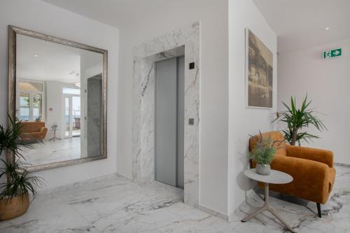 a mirror in a room with a chair and a table at Villa Primordia in Podgora