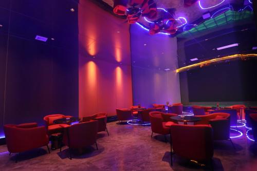 a room with tables and chairs and red lights at DongHu Resort Hotel in Sihanoukville