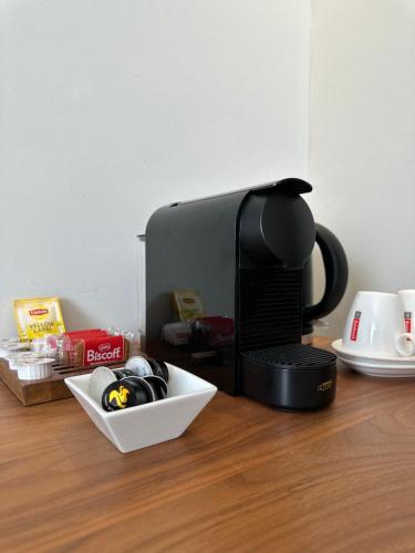 a coffee maker sitting on top of a wooden table at Hotel Vé in Mechelen