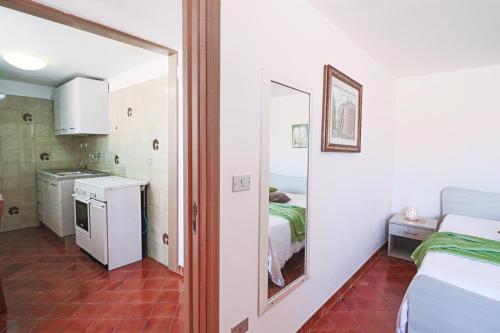 a small room with a bed and a mirror at Casa Isabel a Otranto in Otranto