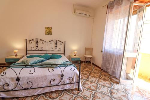 a bedroom with a bed and a large window at Casa Isabel a Otranto in Otranto