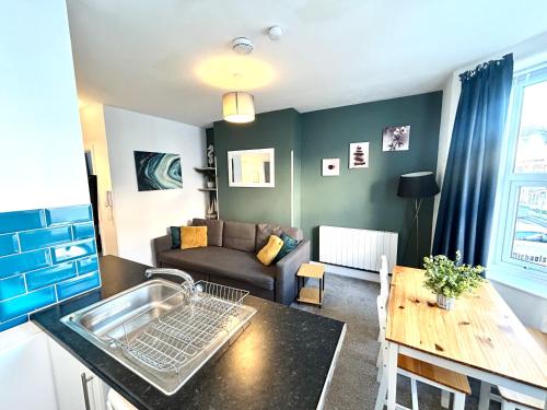 a living room with a couch and a table at Town Centre Apartments by the Beach, BIC, Pavilion in Bournemouth
