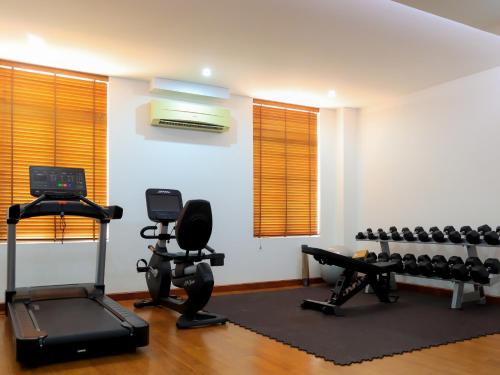 a gym with exercise equipment in a room at Jaya Suites Hotel in Phnom Penh