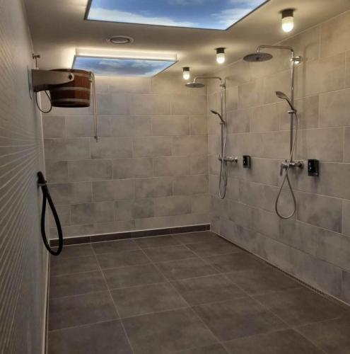 a bathroom with a shower with a shower head at Penthouse am Großen Plöner See in Ascheberg