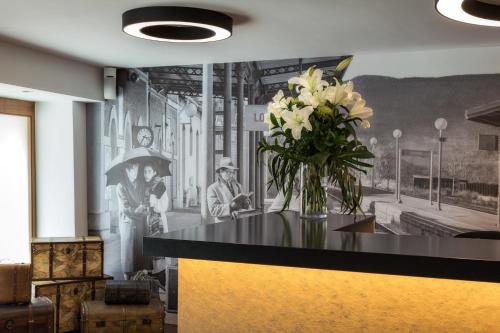 a room with a vase of flowers on a counter at Sercotel Calle Mayor in Logroño