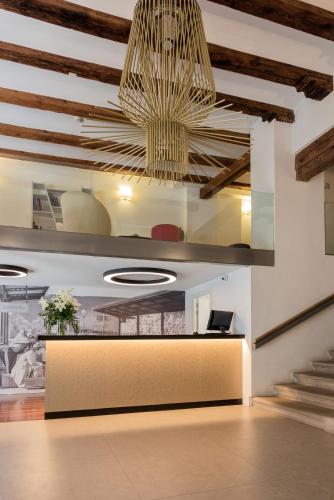 a lobby with a reception desk and a chandelier at Sercotel Calle Mayor in Logroño